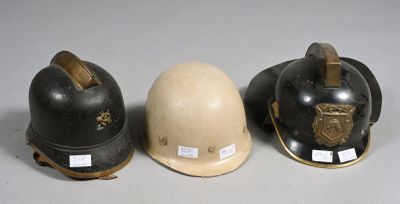 three helmets are lined up in a row on a white surface