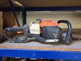 a chainsaw sitting on top of a shelf in a garage