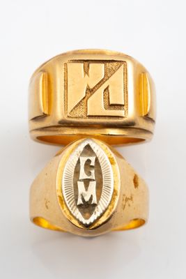 two gold rings with the initials of two men and a woman on them