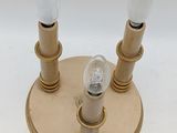 pair of brass plated wall lights with glass bulbs on a white background