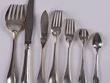 five forks, a knife, a spoon, and a knife on a table