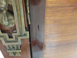 a close up of a wooden cabinet with a metal handle