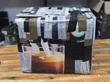 a box of coffee sitting on top of a wooden table