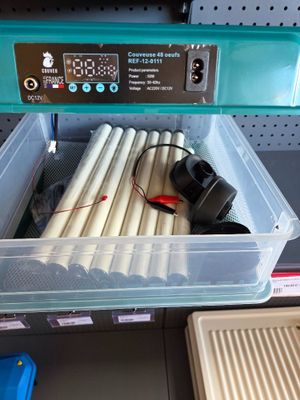 a plastic container with a bunch of pipes inside of it