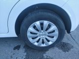 a close up of a tire on a white car