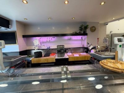 an image of a kitchen with a counter and a pizza on the counter