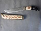 two knives that are laying next to each other on a table