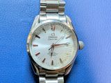 an image of a close up of a watch on a blue surface