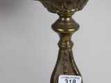 a close up of a brass candle holder on a table
