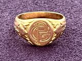 an image of a gold ring on a purple surface