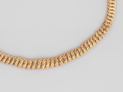 a gold chain necklace on a white background