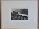 black and white photograph of a building with a clock on top of it