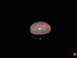 an image of a white fire opal in the dark