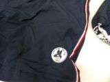 a jacket and hat sitting on a table next to a cell phone