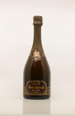 a bottle of champagne sitting on top of a glass table