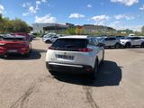 cars are parked in a parking lot with a building in the background