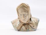 a ceramic bust of a woman with a hood on