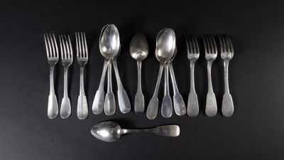 a lot of silver spoons and forks on a black table