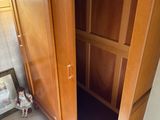 a wooden cabinet with a tv on top of it