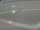 a close up of a car ' s hood with a remote control