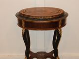 an image of a small table with a wooden top on a floor
