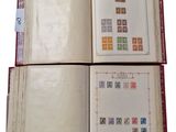 an open book with stamps on it sitting on top of a table