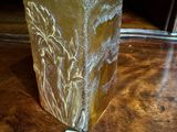 a glass vase with a sticker on it on a table