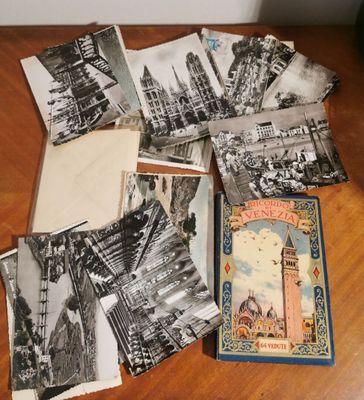 several old postcards of different cities and buildings on a table
