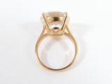 a close up of a gold ring with a white topaz stone