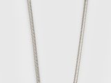 a white pearl pendant on a silver chain on a white background