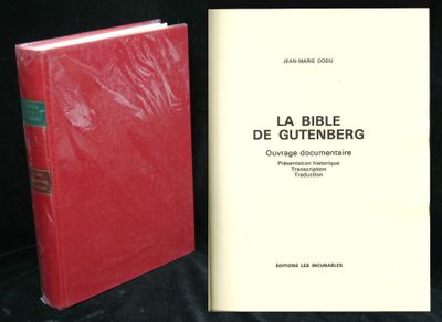 two books sitting next to each other on a black surface