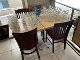 a table with a lot of empty wine glasses on it