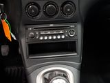 a car dashboard with a clock, radio, and other items in it