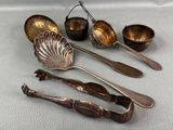 five spoons and two spoons sitting on a table