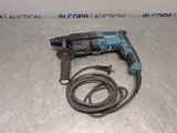 a corded drill is laying on the floor next to a cord
