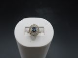 an image of a ring with a blue stone in it