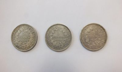 three silver coins, one of which is a sovereign and one of which is a sovereign