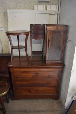 a dresser and a chair in the corner of a room