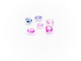 a group of pink, blue and white gems on a white surface