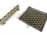two pieces of metal with holes in them on a white surface