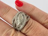 a woman ' s hand holding a ring with a diamond on it