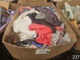 a cardboard box filled with clothes and other items