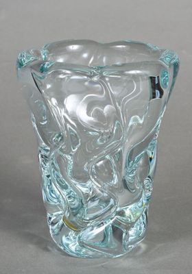 a glass vase with a design on it on a table