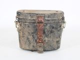 an old metal box with a handle on a white surface