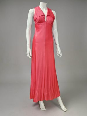 a mannequin wearing a pink dress with a collared neckline
