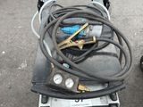 two air compressors on a cart in the parking lot