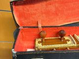 a black suitcase with a red lining and a wooden handle