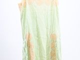 an image of a green top hanging on a hanger