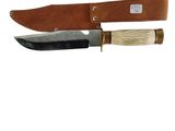 a picture of a knife with a leather sheath on it