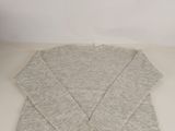 a close up of a sweater on a table with a white background